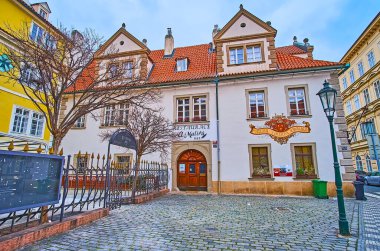 PRAGUE, CZECH REPUBLIC - MARCH 6, 2022: Maltese Square historic architecture with a view on small restaurant, Lesser Quarter, on March 6 in Prague