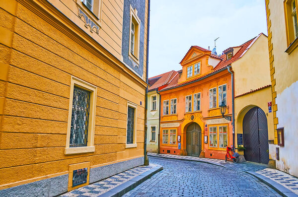 PRAGUE, CZECH REPUBLIC - MARCH 6, 2022: The small colored historic houses in narrow curved streets of Lesser Quarter, on March 6 in Prague