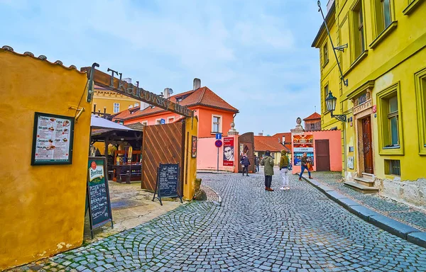 PRAGUE, CZECH REPUBLIC - MARCH 6, 2022: Cihelna Street with old houses and gate of Tkalcovsky Dvur courtyard, Lesser Quarter, on March 6 in Prague