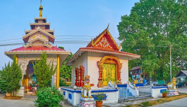 Panorama of Wat Pa Kham Temple with richly decorated shrines with Singha (Chinthe) Lions, Naga serpents on the bargeboards, Pai, Thailand
