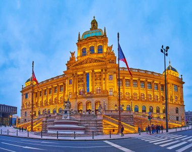 PRAGUE, CZECH REPUBLIC - MARCH 6, 2022: The evening panorama of brightly illuminated National Museum building from Wenceslas Square, on March 6 in Prague