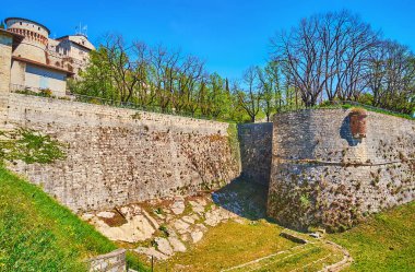 Explore Cidneo Hill landmarks with medieval stone Castle of Brescia with ramparts, bastions, deep moat, towers and park, Brescia, Lombardy, Italy
