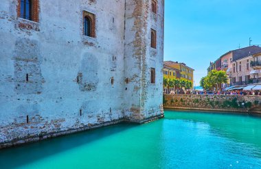 The rippled waters of the moat of Scaligero Caslte, located in Sirmione old town, Italy