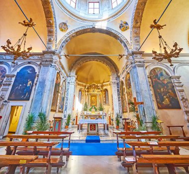 BRESCIA, ITALY - APRIL 10, 2022: Ornate historic altar of Santa Maria dei Miracoli Church with carved arches, icons and flowers in pots, on April 10 in Brescia