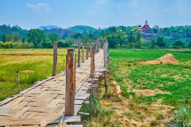The scenic Su Tong Pae bamboo bridge amid the green agricultural lands, Mae Hong Son suburb, Thailand