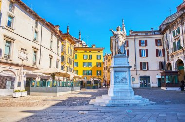 Piazza della Loggia Square with La Bella Italia marble statue, outdoor restaurants and historic houses, Brescia, Italy