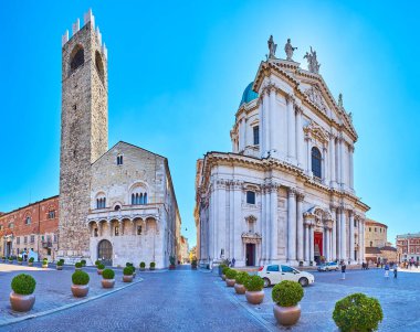 BRESCIA, ITALY - APRIL 10, 2022: Panorama of Piazza Paolo VI with Duomo Vecchio (Old Cathedral), Duomo Nuovo (New Cathedral) and Palazzo Broletto palace, on April 10 in Brescia