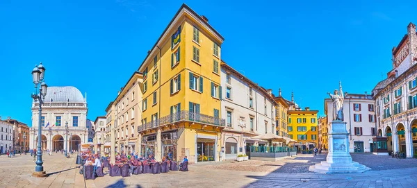 BRESCIA, ITALY - APRIL 10, 2022: Panorama of Piazza della Loggia Square with La Bella Italia marble statue, outdoor restaurants, Palazzo della Loggia palace, on April 10 in Brescia