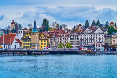 LUCERNE, SWITZERLAND - MARCH 30, 2022: Historical buildings of Schwanenplatz on the bank of Reuss river, on March 30 in Lucerne, Switzerland