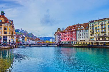 LUCERNE, SWITZERLAND - MARCH 30, 2022: Medieval buildings on the banks of Reuss river, on March 30 in Lucerne, Switzerland