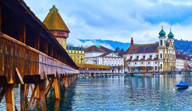 Kapellbrucke, the wooden medieval bridge across Reuss river, and the stone Water tower (Wasserturm) in Lucerne, Switzerland