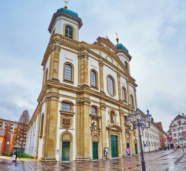 LUCERNE, SWITZERLAND - MARCH 30, 2022: Jesuit Church on the bank of Reuss river, on March 30 in Lucerne, Switzerland