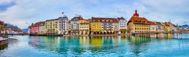 LUCERNE, SWITZERLAND - MARCH 30, 2022: Panorama of Altstadt of Lucerne with gorgeous buildings on its embankment, on March 30 in Lucerne, Switzerland