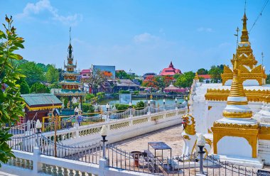 The statue of Chinthe (Singha) lion at the carved white-golden Chedi of Wat Chong Klang Temple, Mae Hong Son, Thailand