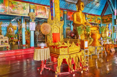MAE HONG SON, THAILAND - MAY 6, 2019: The Main Viharn of Wat Chong Klang Temple with wicker image of Buddha, surrounded with flowers, sculptures and paintings, on May 6 in Mae Hong Son