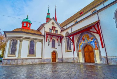 Historical Franciscan Church (Franziskanerkirche) with colorful painted entrance, Lucerne, Switzerland