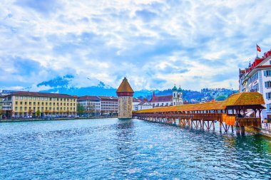 Enjoy magnificent view on medieval symbols of Lucerne, the Kapellbrucke wooden bridge and Wasserturm tower, Switzerland