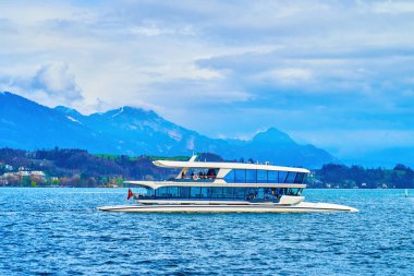 Modern hybrid electric Catamaran sails on Alpine Lake Lucerne, Lucerne, Switzerland