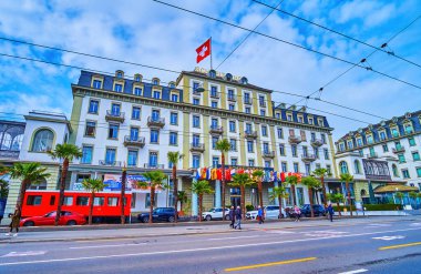 LUCERNE, SWITZERLAND - MARCH 30, 2022: Facade of Schweizerhof Hotel on Schweizerhofquai embankment, on March 30 in Lucerne, Switzerland