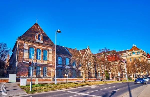 The facade of the scenic vintage building of Technology and Economics University, Budapest, seen from embankment of Danube River, Hungary