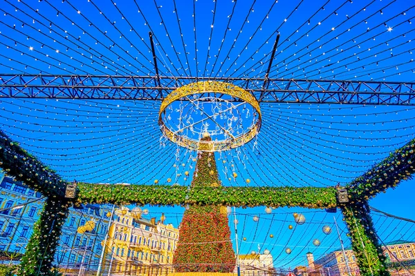 Decorative gate of Christmas Fair on Sophia Square with Christmas Tree on background Kyiv, Ukraine