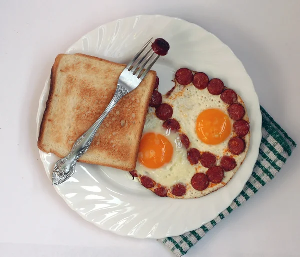 Breakfast with eggs and sausages on a plate — Stock Photo, Image