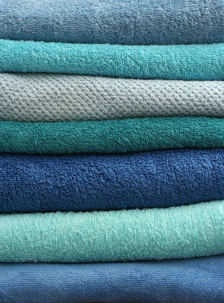 Stacked light blue bath towels — Stock Photo, Image