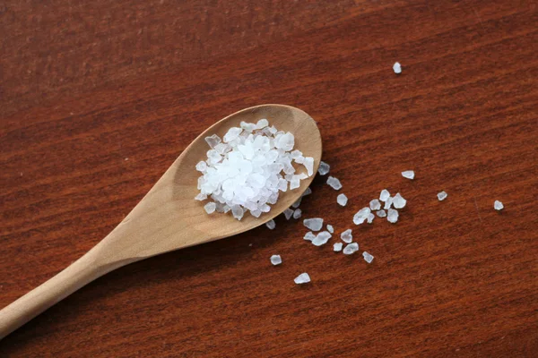 Sea salt in wooden spoon soft focus — Stock Photo, Image