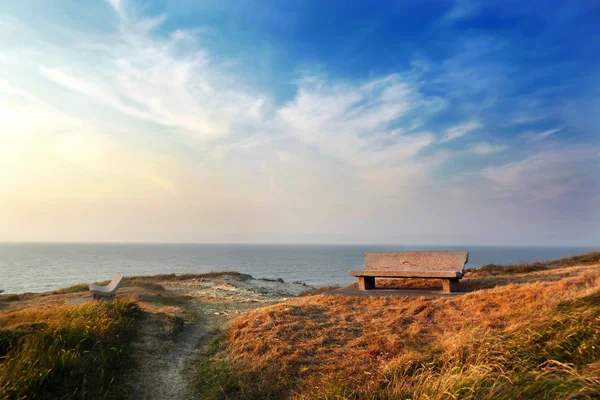 Stone seats at sunset in Sopelana coast — Stock Photo, Image