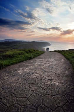 romantic scene of two person walking at sunset clipart