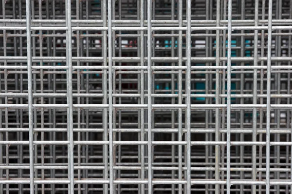 Background of squares on a heap of metallic fences — Stock Photo, Image