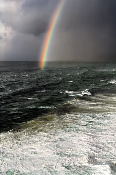 Storm with rainbow and rough sea — Stock Photo, Image