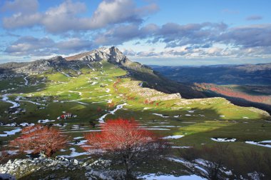 meadows surrounding by mountains in Gorbea. Basque Country clipart