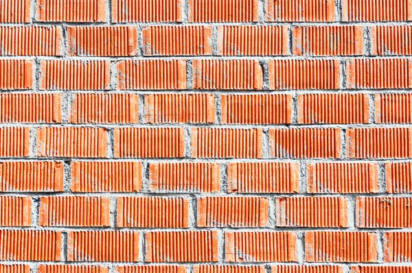 Wall of red bricks with cement — Stock Photo, Image