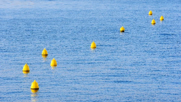 Yellow buoys on water — Stock Photo, Image