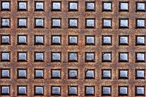 Metallic textures on sewer manhole — Stock Photo, Image