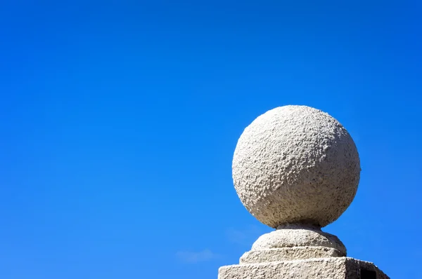 Stone ball against blue sky — Stock Photo, Image
