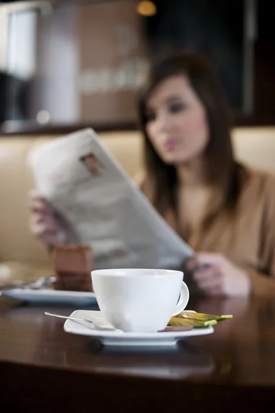 Reading newspaper in cafe — Stock Photo, Image