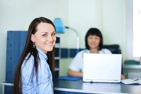 微笑着的年轻妇女在医生办公室 — 图库照片