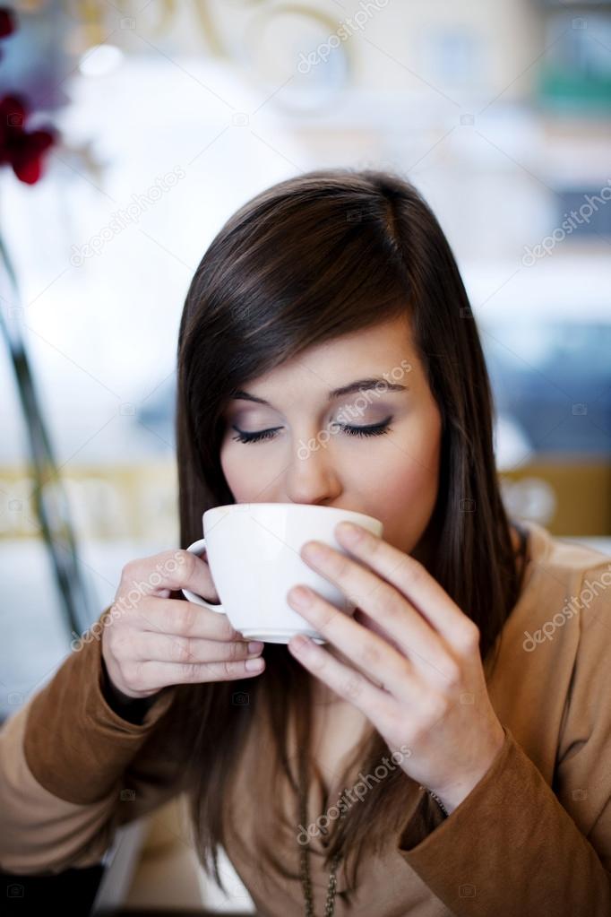 Close up of woman drinking coffe