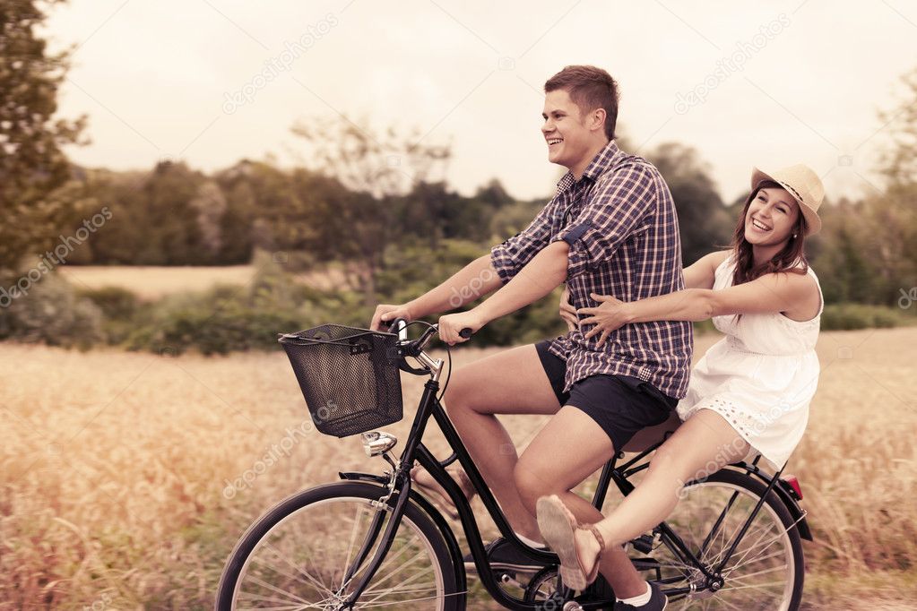 Couple have fun riding on bike