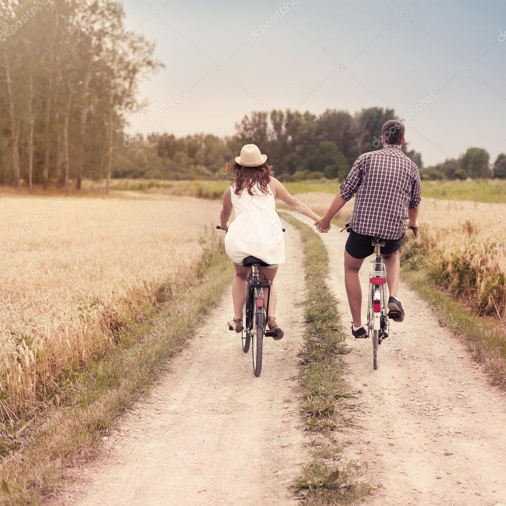 Romantic couple cycling together at the day