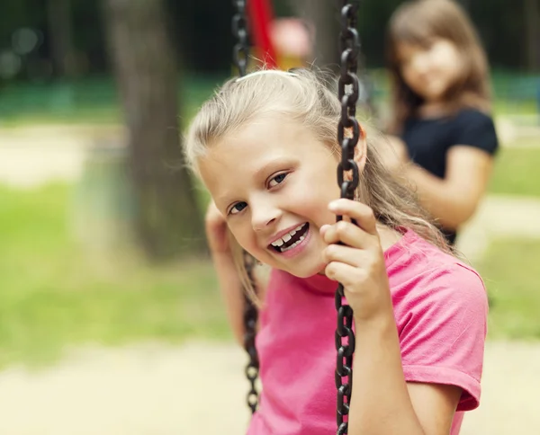 Happy little kid on swing — Stock Photo, Image