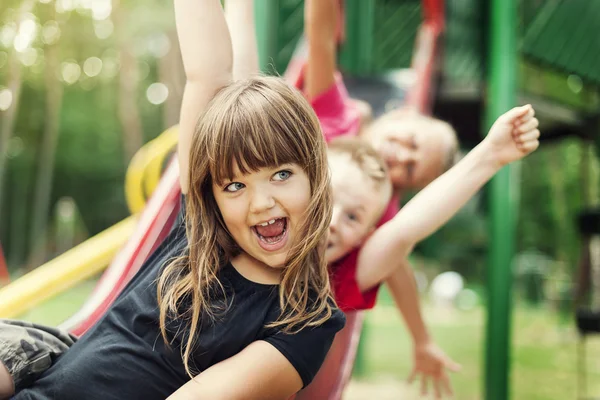 Kids having fun on slide — Stock Photo, Image