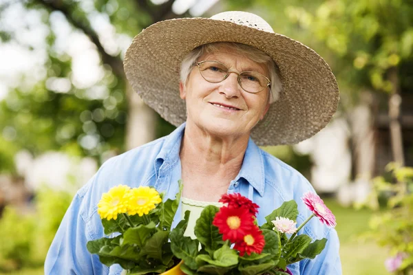 Mujer mayor con flores —  Fotos de Stock