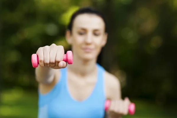 Young woman with dumbbells — Stock Photo, Image