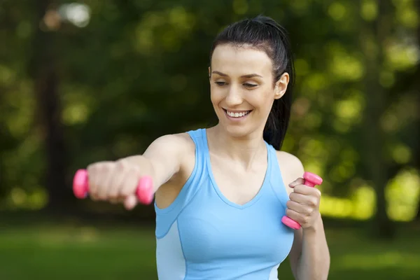 Young woman with dumbbells — Stock Photo, Image