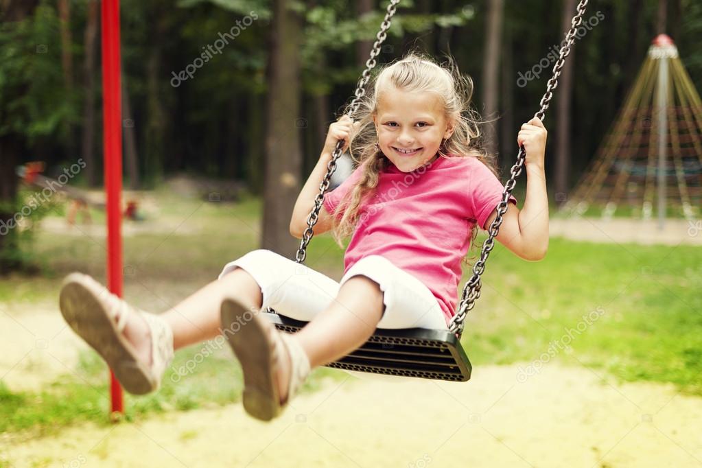 happy girl swinging on playground | 图库照片 08 anna bizoń