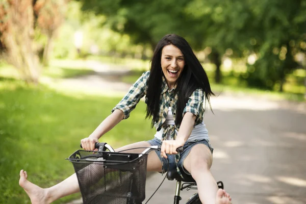 Mulher de bicicleta através do parque — Fotografia de Stock