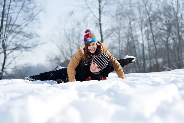 Casal jovem trenó na neve — Fotografia de Stock